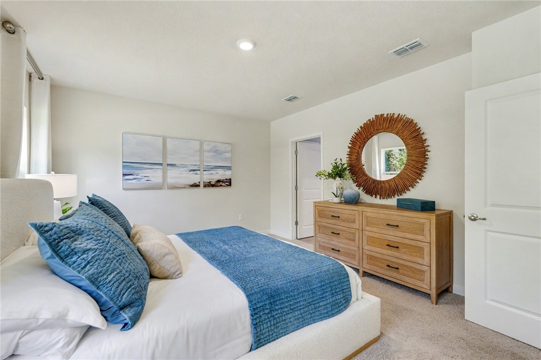 793 George Street Sebastian, FL 32958 - Photo 19 of 22 a bedroom with a bed and a dresser