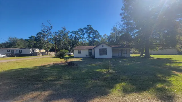 a view of a house with a yard and tree s