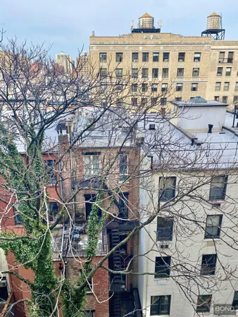 a view of a large building with a tree