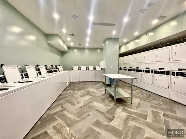 a large room with lots of furniture and white appliances