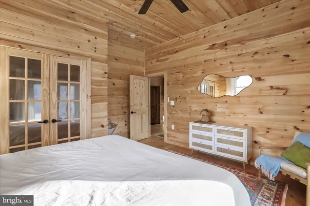 a bed sitting in a spacious bedroom next to a window