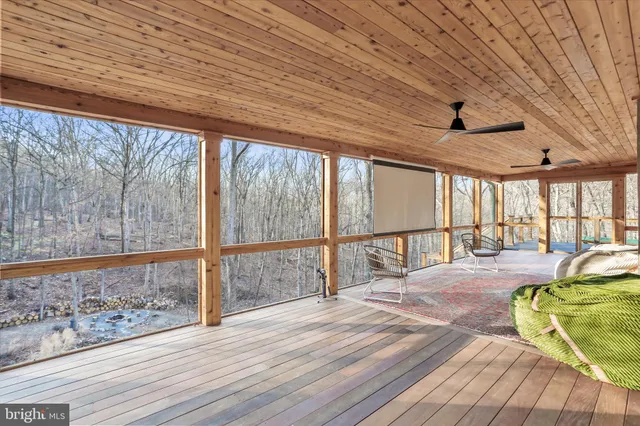 a view of a porch with a table and chairs and ice gate