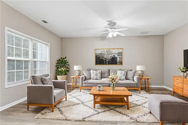 a living room with furniture a table and a window