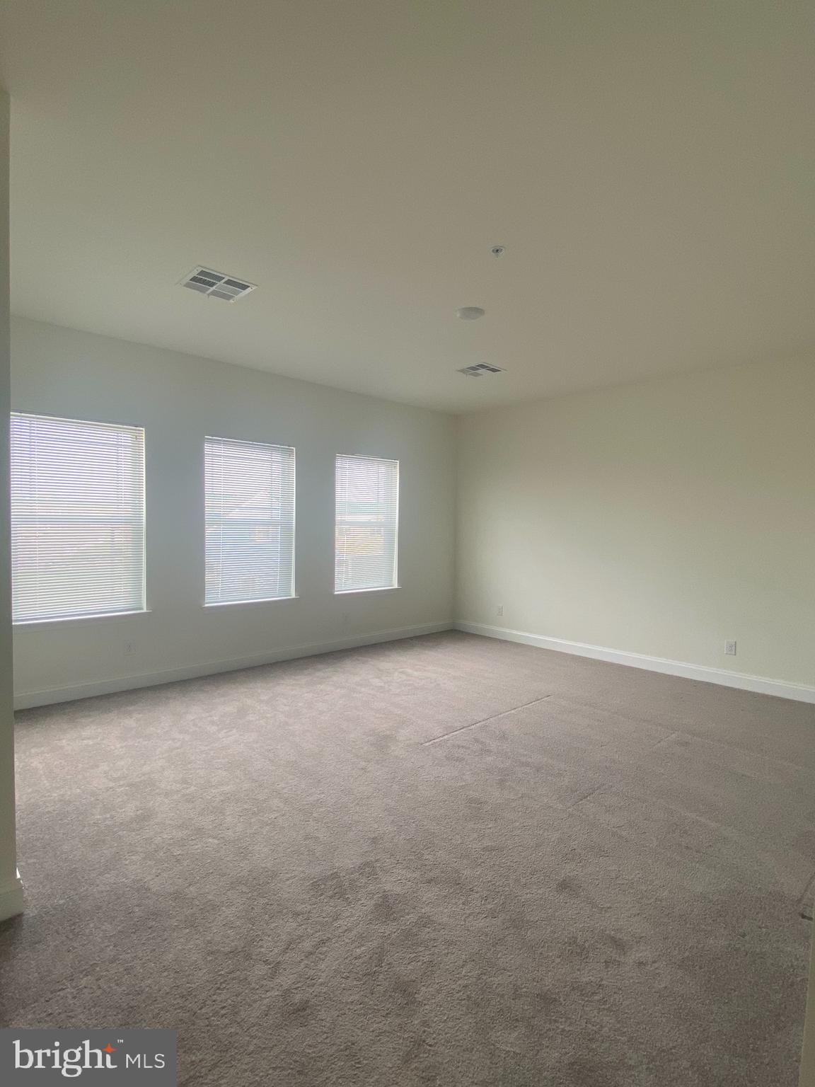 1812 Main Street, Unit 202 Chester, MD 21619 - Photo 13 of 32 an empty room with windows
