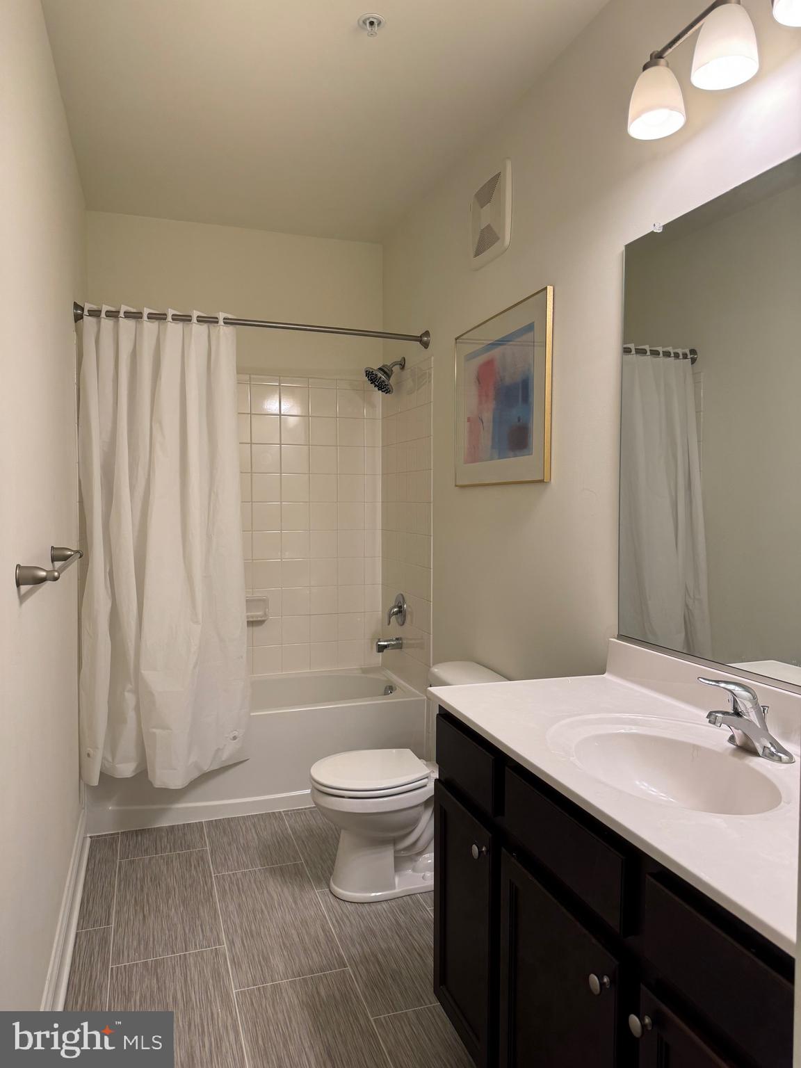 1812 Main Street, Unit 202 Chester, MD 21619 - Photo 17 of 32 a bathroom with a sink a toilet and shower
