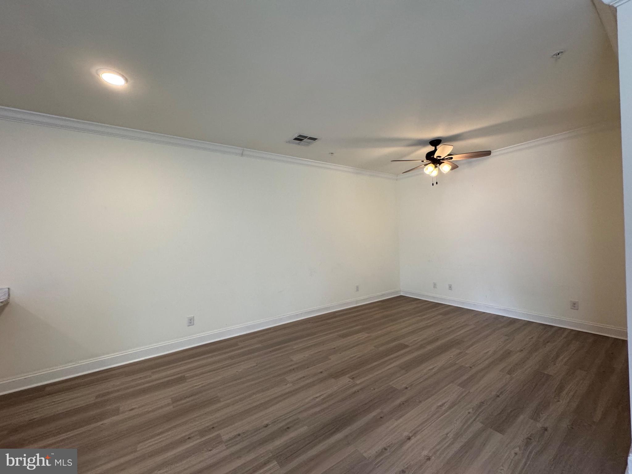 1812 Main Street, Unit 202 Chester, MD 21619 - Photo 21 of 32 a view of an empty room with wooden floor