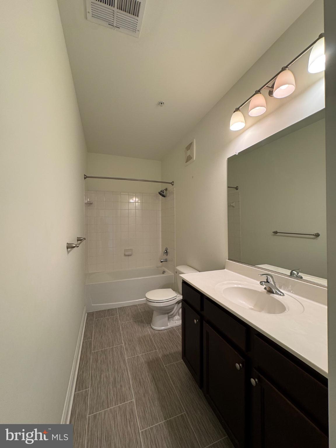 1812 Main Street, Unit 202 Chester, MD 21619 - Photo 26 of 32 a bathroom with a sink a toilet and shower