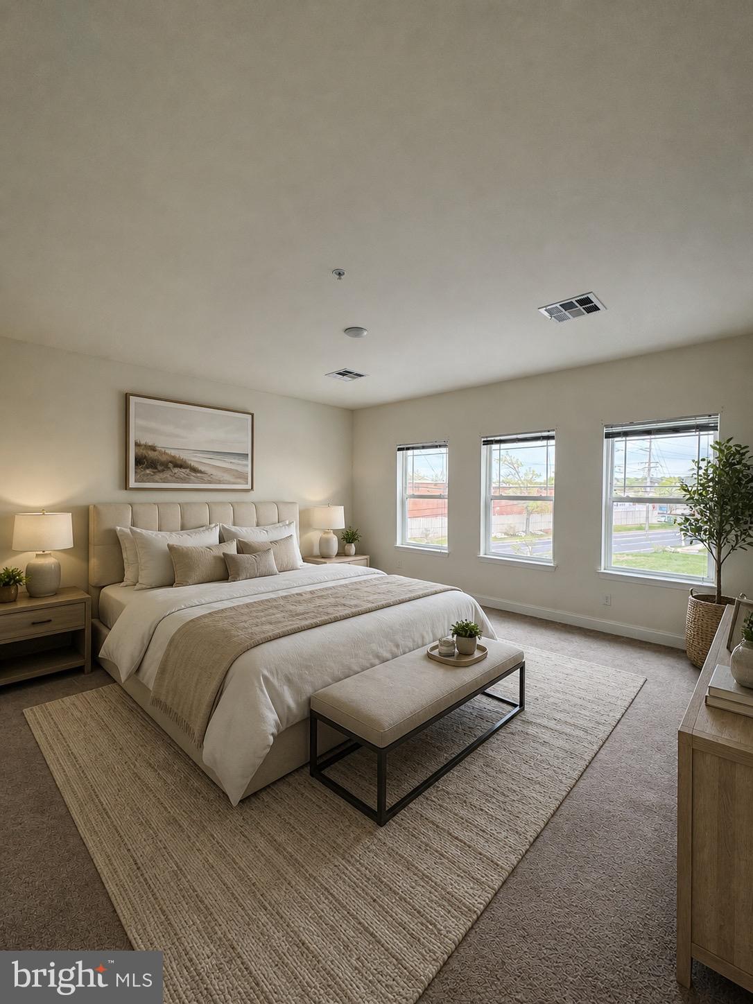1812 Main Street, Unit 202 Chester, MD 21619 - Photo 4 of 32 a spacious bedroom with a bed a couch and windows