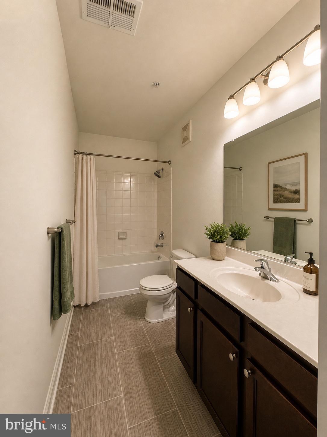 1812 Main Street, Unit 202 Chester, MD 21619 - Photo 5 of 32 a bathroom with a sink a toilet and shower