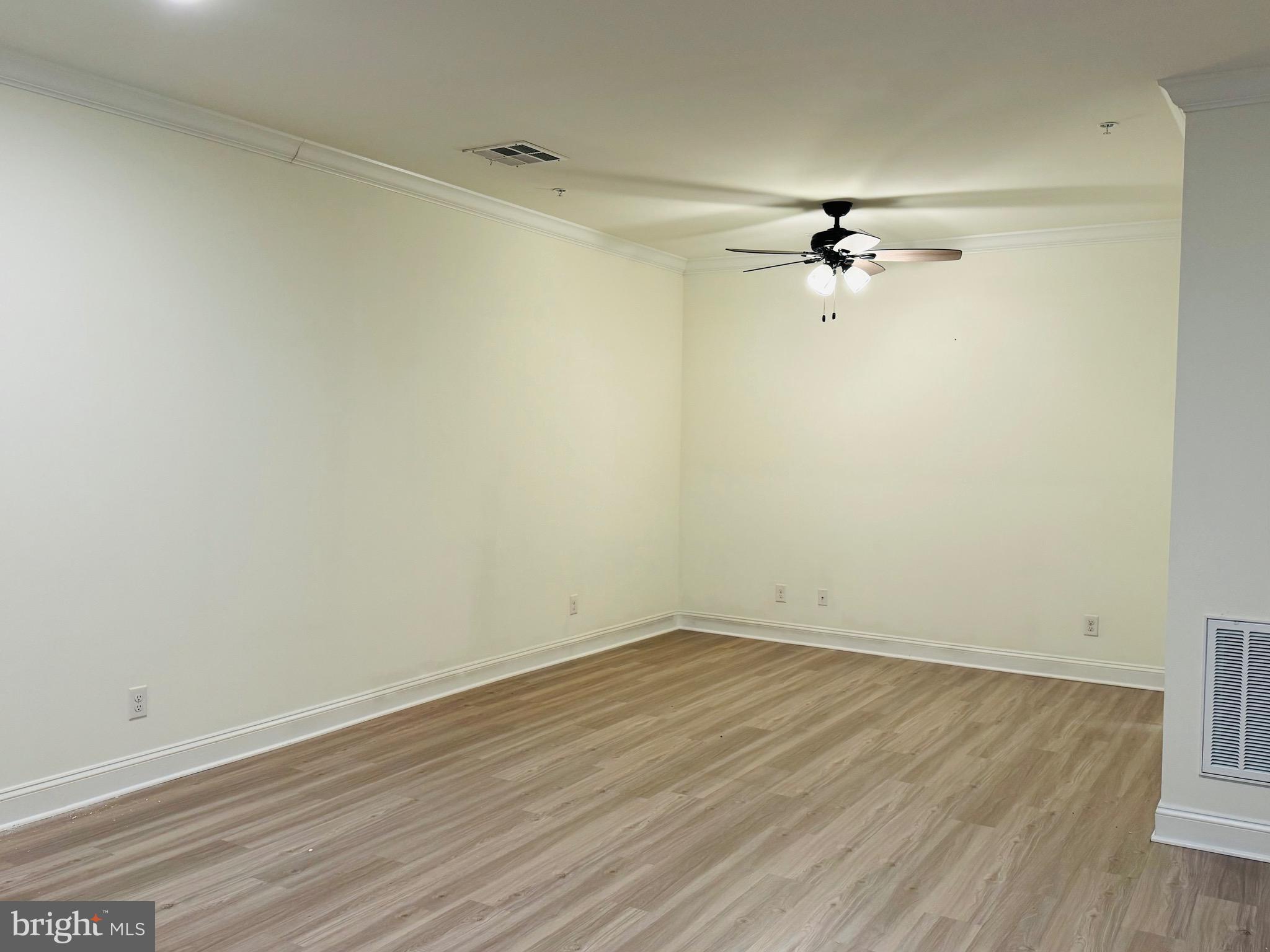 1812 Main Street, Unit 202 Chester, MD 21619 - Photo 9 of 32 wooden floor in a empty room