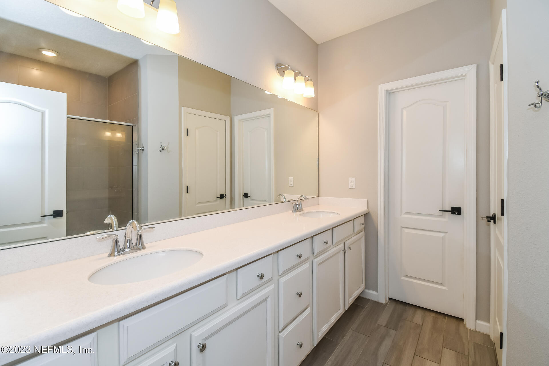 58 Martello Drive St. Augustine, FL 32092 - Photo 14 of 26 a bathroom with a double vanity sink and a mirror