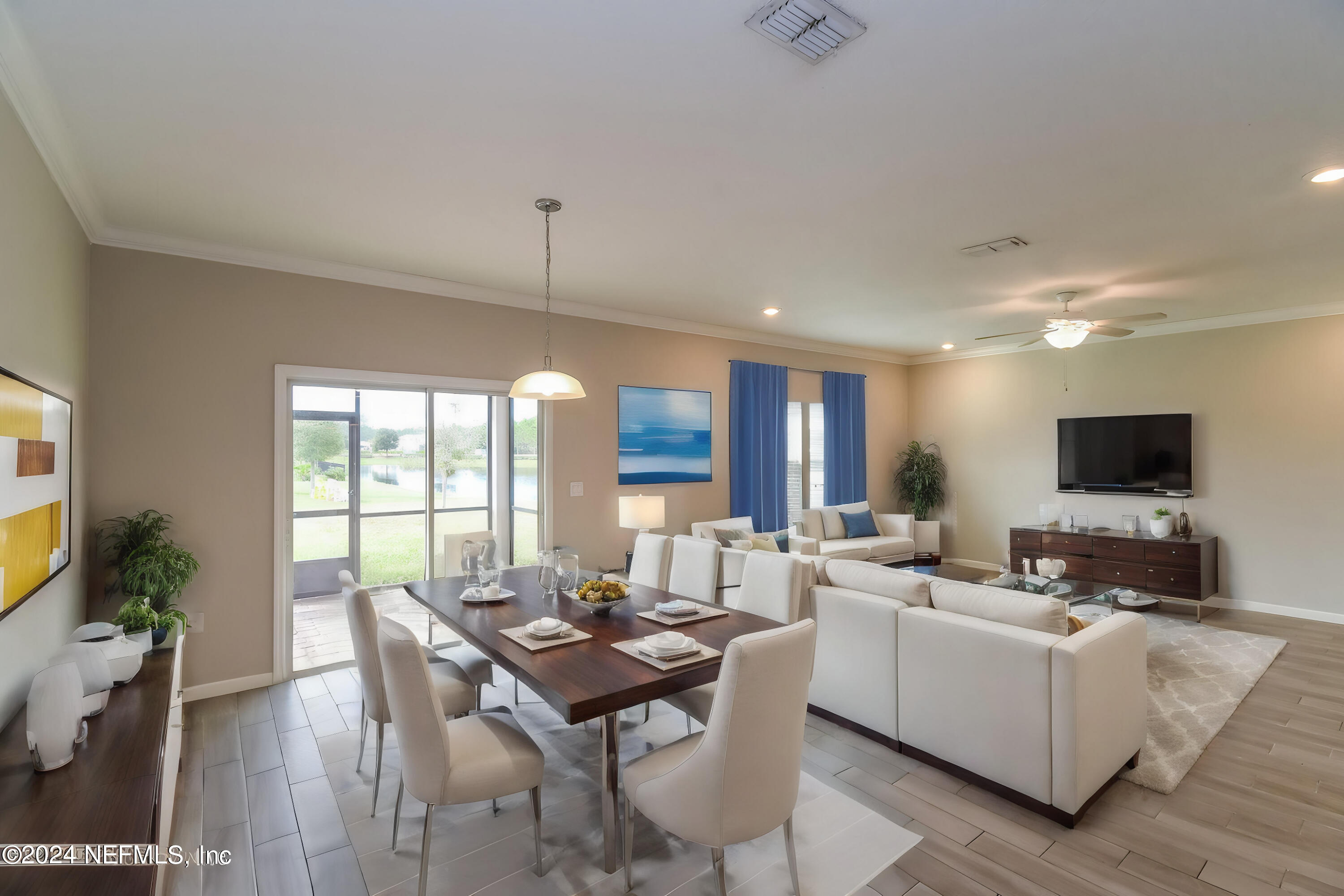 58 Martello Drive St. Augustine, FL 32092 - Photo 3 of 26 a living room with furniture a flat screen tv and a large window
