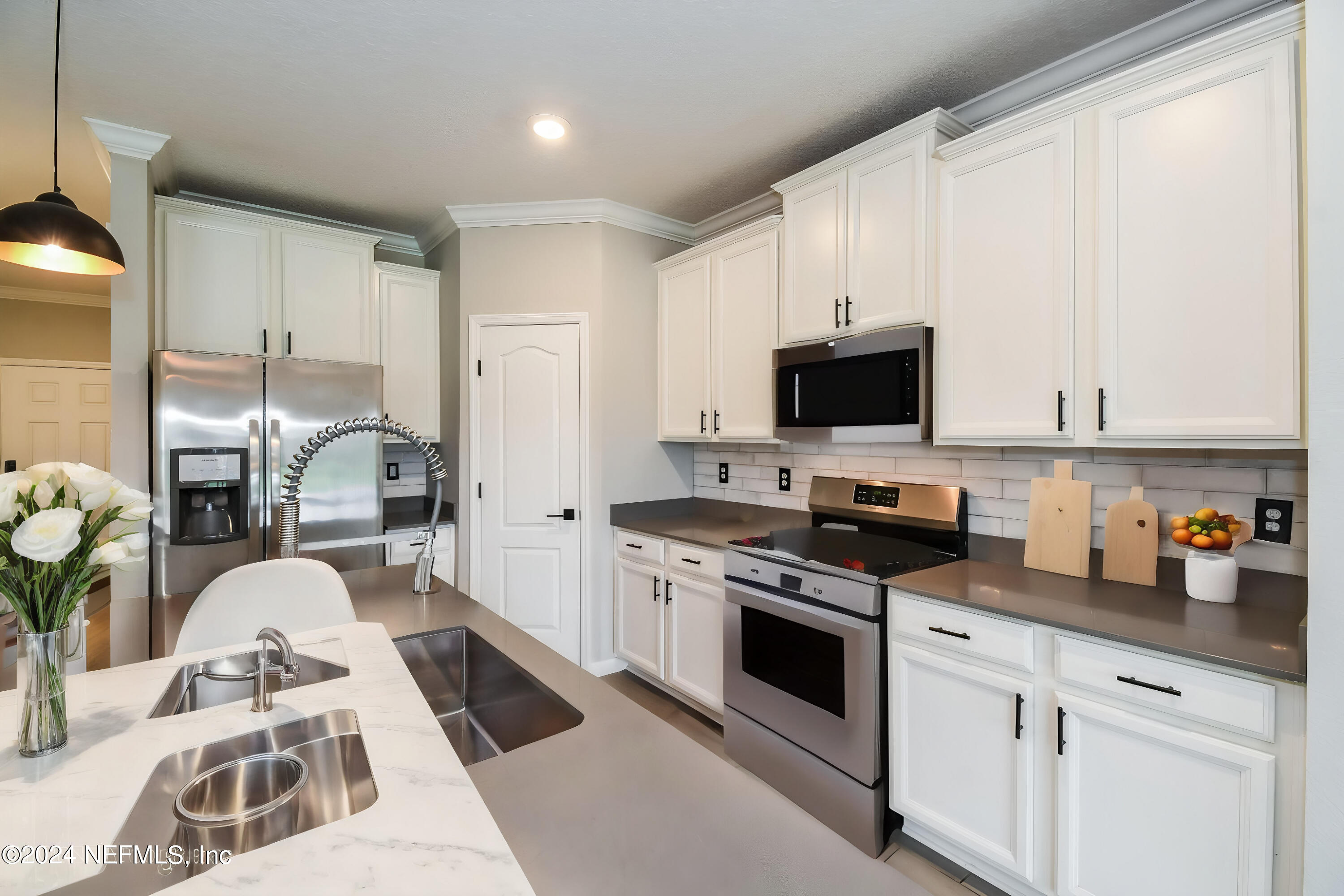 58 Martello Drive St. Augustine, FL 32092 - Photo 4 of 26 a kitchen with stainless steel appliances granite countertop a stove a sink and a white cabinets
