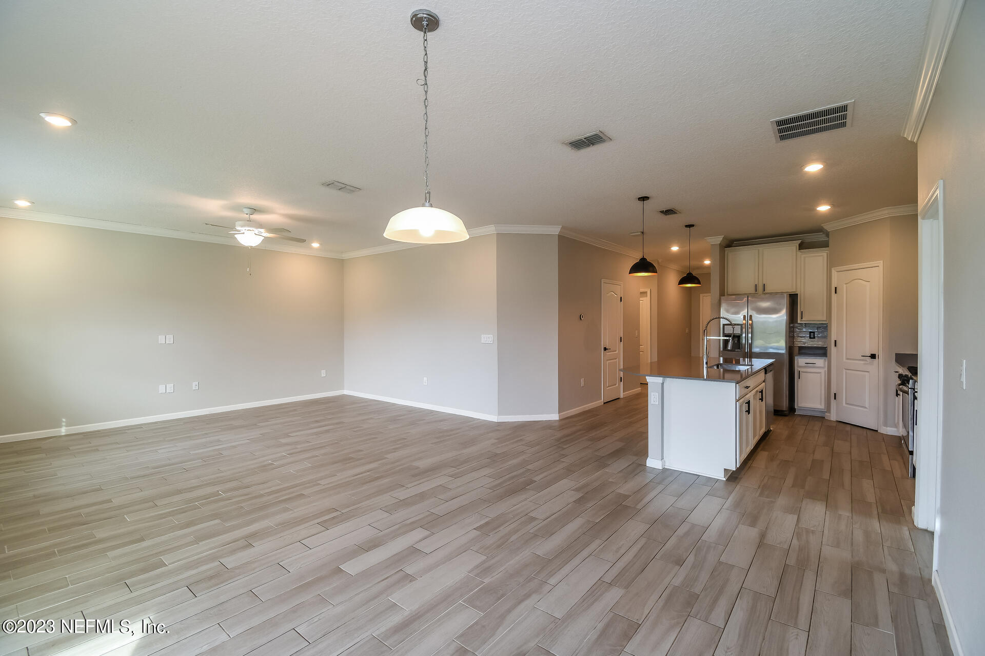 58 Martello Drive St. Augustine, FL 32092 - Photo 6 of 26 a view of a big room with wooden floor and a kitchen