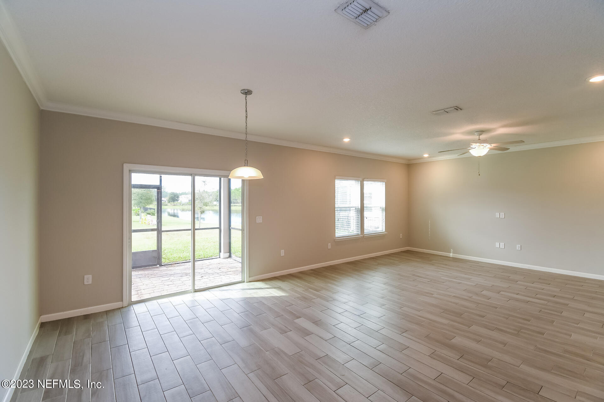 58 Martello Drive St. Augustine, FL 32092 - Photo 7 of 26 an empty room with wooden floor and windows
