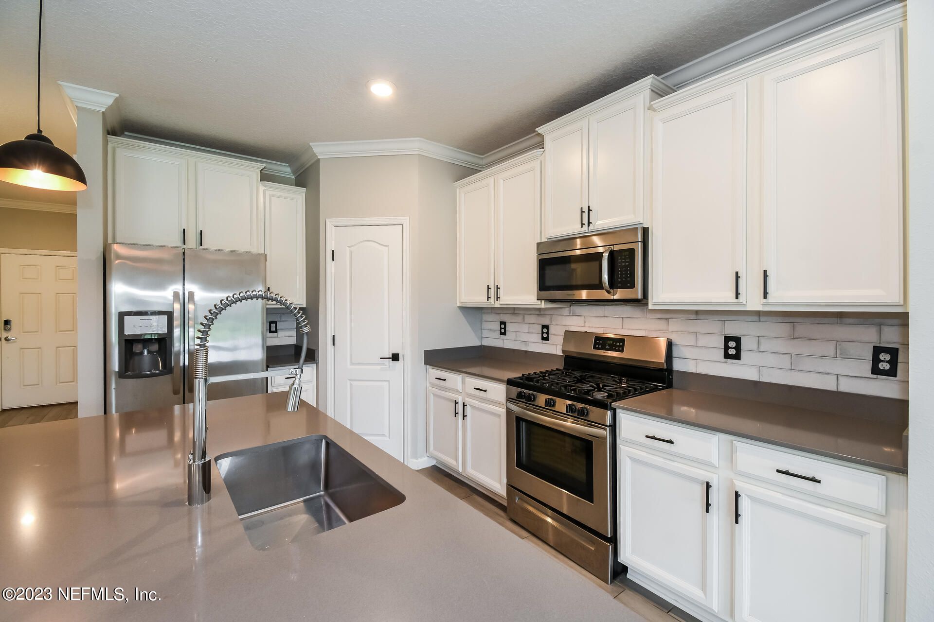 58 Martello Drive St. Augustine, FL 32092 - Photo 9 of 26 a kitchen with granite countertop a stove a sink and a refrigerator