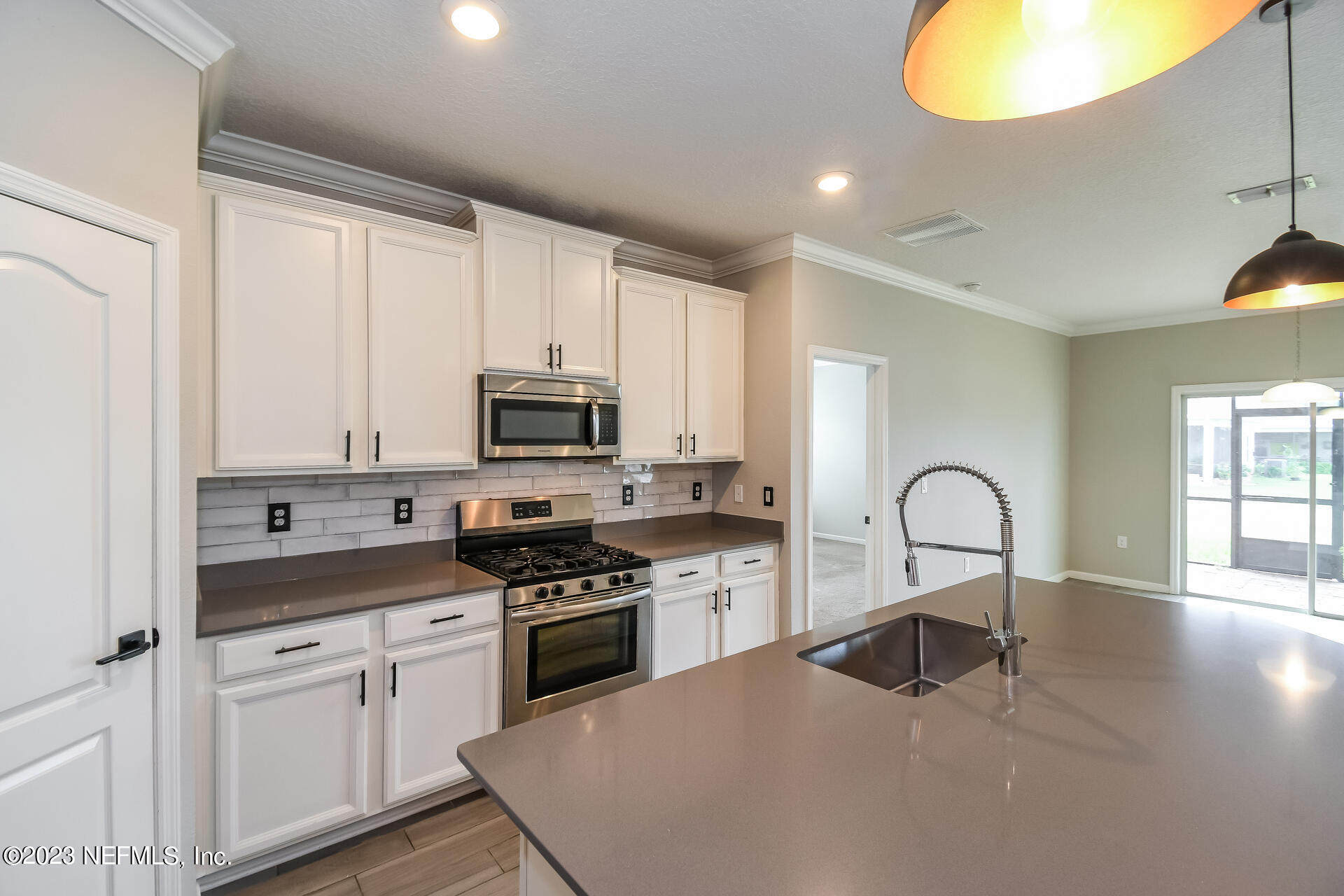 58 Martello Drive St. Augustine, FL 32092 - Photo 10 of 26 a kitchen with stainless steel appliances granite countertop a stove a sink and a microwave