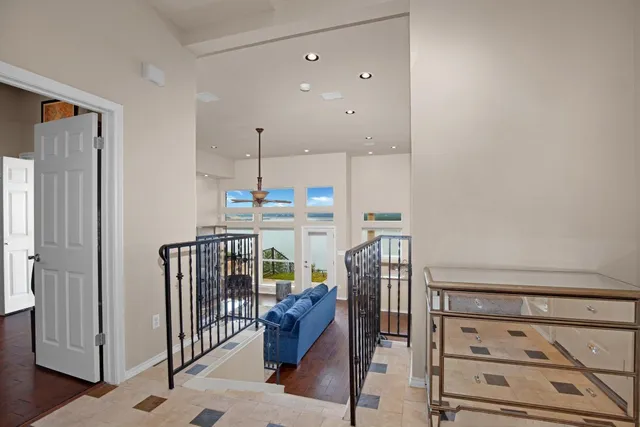 a living room with furniture a flat screen tv and a table