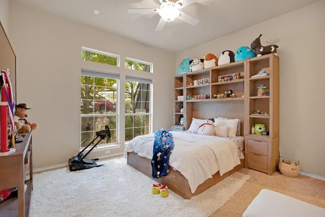 a bedroom with a bed a shelf and books