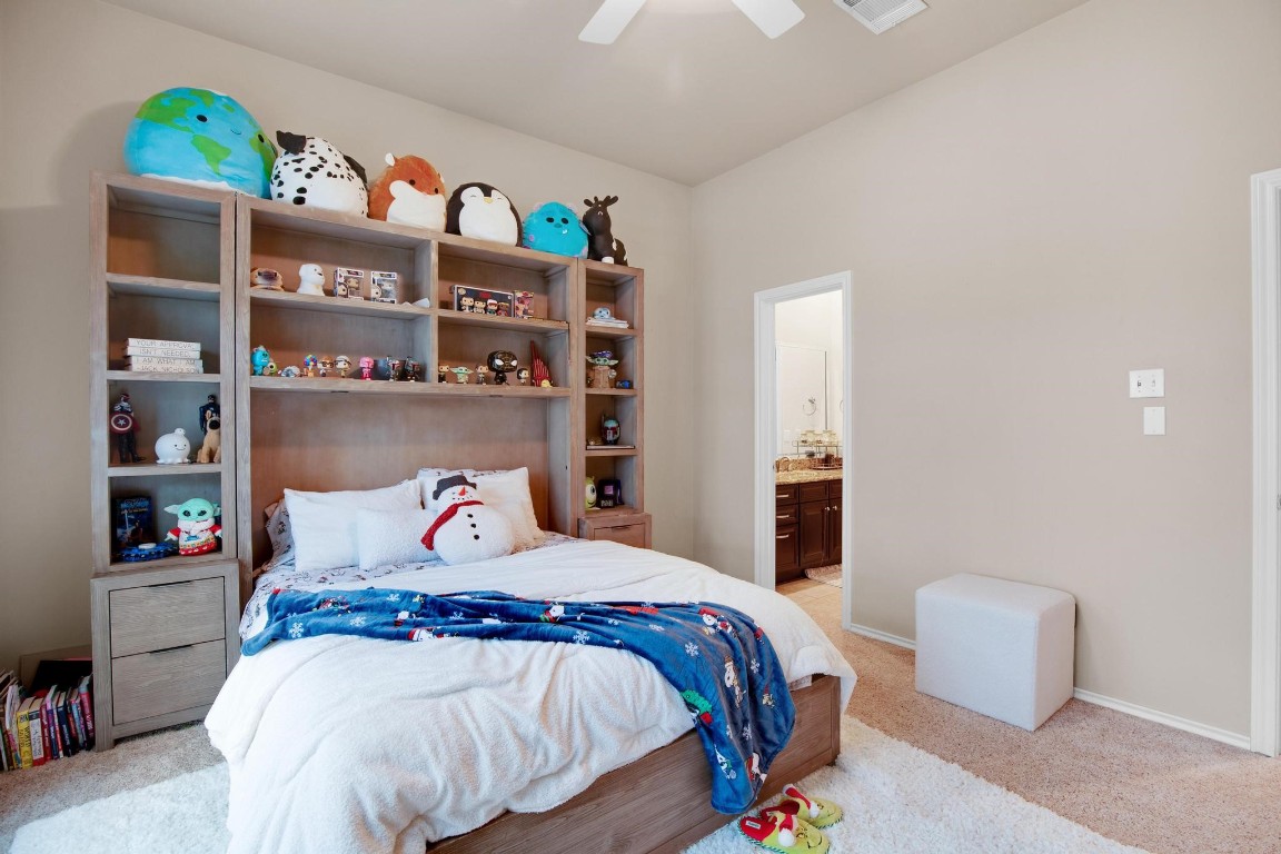 2918 Ranch Road 620 North, Unit L177 Austin, TX 78734 - Photo 22 of 40 a bedroom with a bed a shelf and books