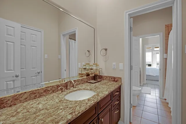 a spacious bathroom with a granite countertop sink mirror and bathtub