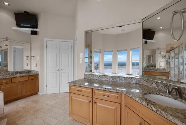a bathroom with a tub sink and mirror