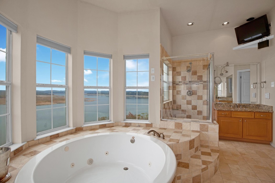 2918 Ranch Road 620 North, Unit L177 Austin, TX 78734 - Photo 25 of 40 a bathroom with a tub sink and mirror