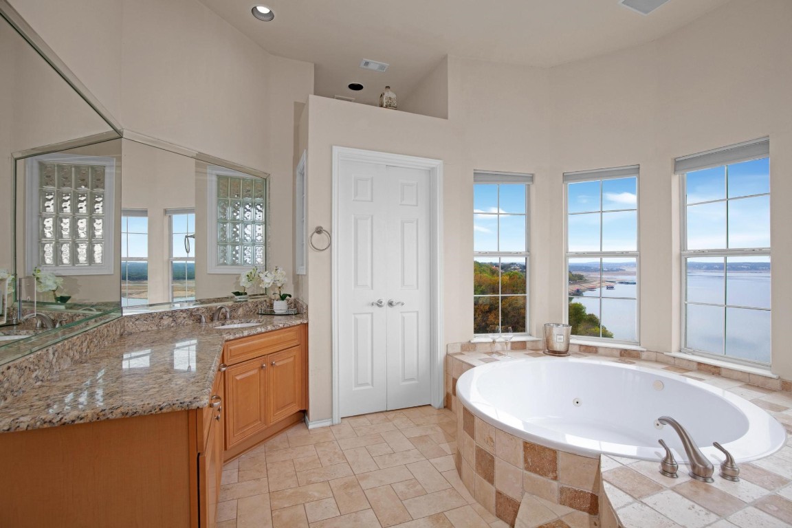 2918 Ranch Road 620 North, Unit L177 Austin, TX 78734 - Photo 26 of 40 a large bathroom with a granite countertop tub and a sink
