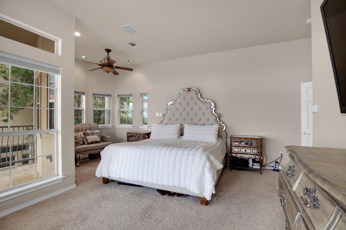 2918 Ranch Road 620 North, Unit L177 Austin, TX 78734 - Photo 27 of 40 a bedroom with a bed and a chandelier