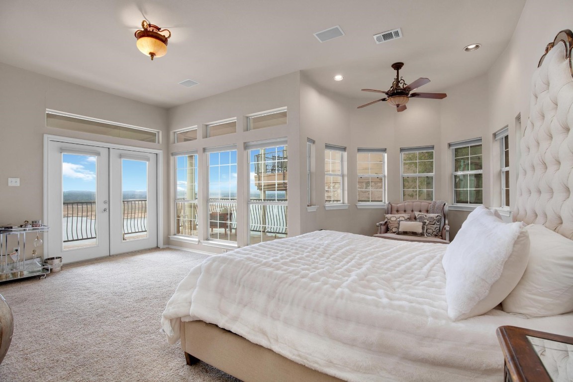 2918 Ranch Road 620 North, Unit L177 Austin, TX 78734 - Photo 4 of 40 a spacious bedroom with a large bed and a chandelier