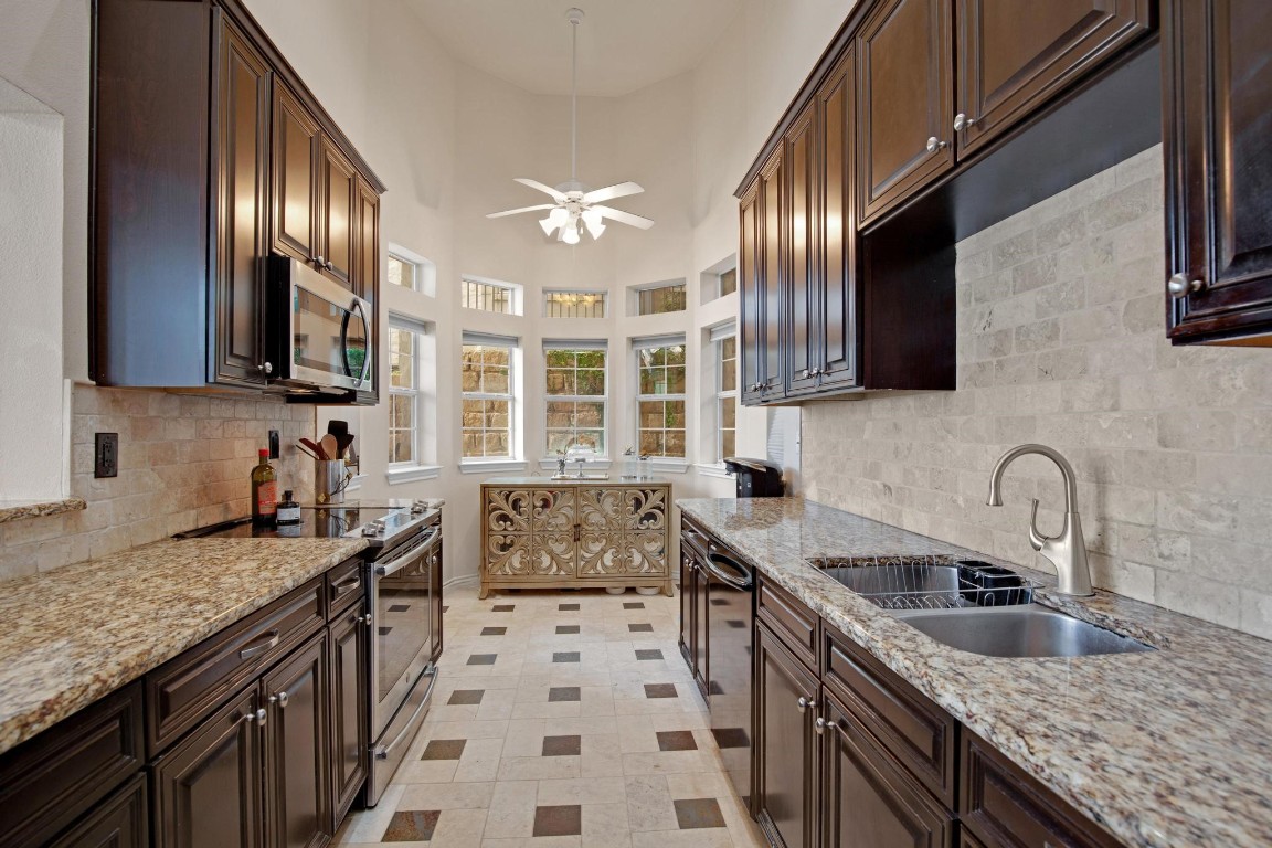 2918 Ranch Road 620 North, Unit L177 Austin, TX 78734 - Photo 5 of 40 a kitchen with stainless steel appliances granite countertop a sink stove and cabinets