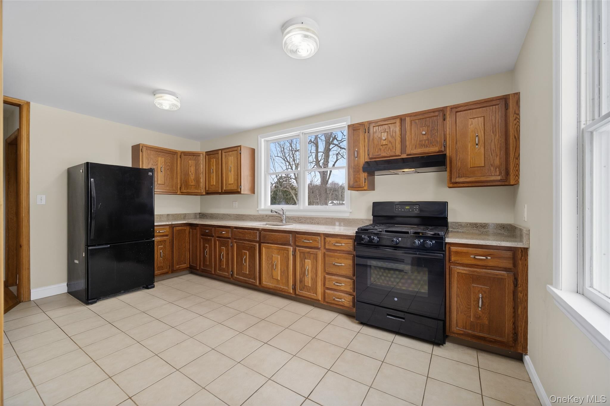 408 Bull Mill Road, Unit 2 Chester, NY 10918 - Photo 8 of 36 Kitchen featuring black appliances, wood finish cabinetry, and light tile patterned floors