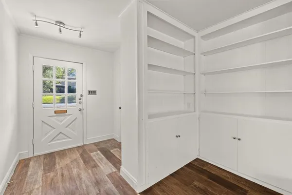a view of storage and utility room with wooden floor