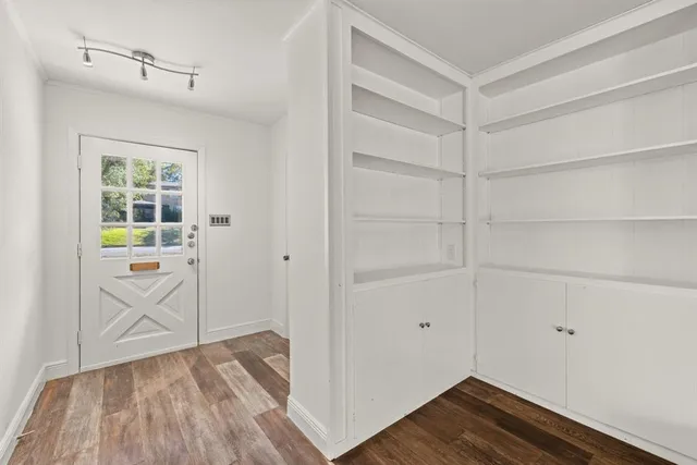 a view of storage and utility room with wooden floor