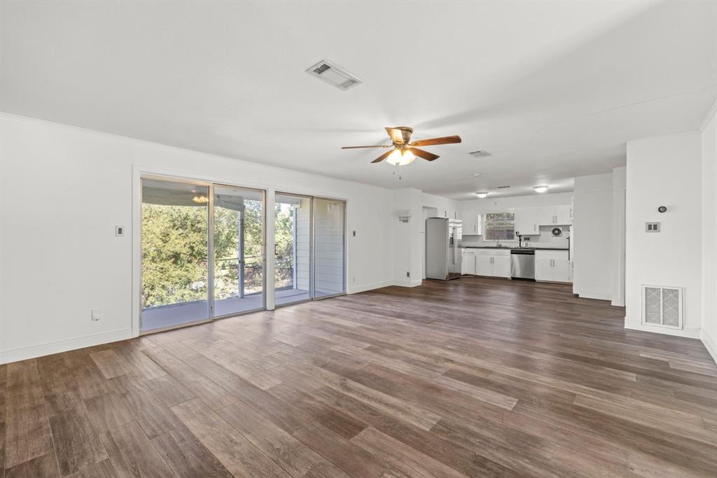 2326 Hartford Road Austin, TX 78703 - Photo 3 of 18 a view of empty room with wooden floor and window