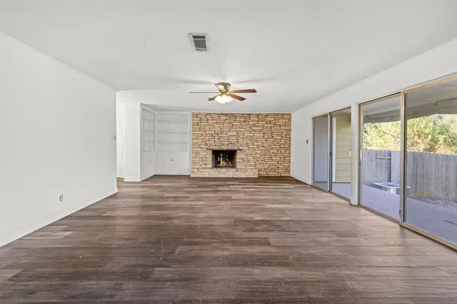 wooden floor in an empty room with a fireplace