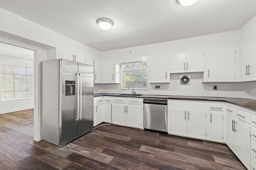 2326 Hartford Road Austin, TX 78703 - Photo 8 of 18 a kitchen with granite countertop white cabinets and stainless steel appliances