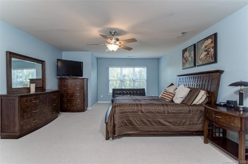 6106 Cactus Valley Road Charlotte, NC 28277 - Photo 14 of 24 a bedroom with a bed a dresser and flat screen tv