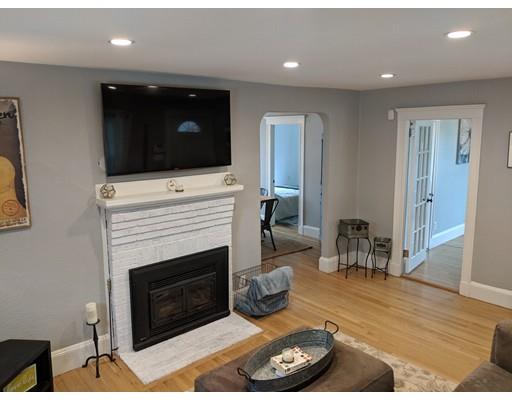 54 Bluff Road Weymouth, MA 02191 - Photo 3 of 13 a living room with furniture a flat screen tv and a fireplace