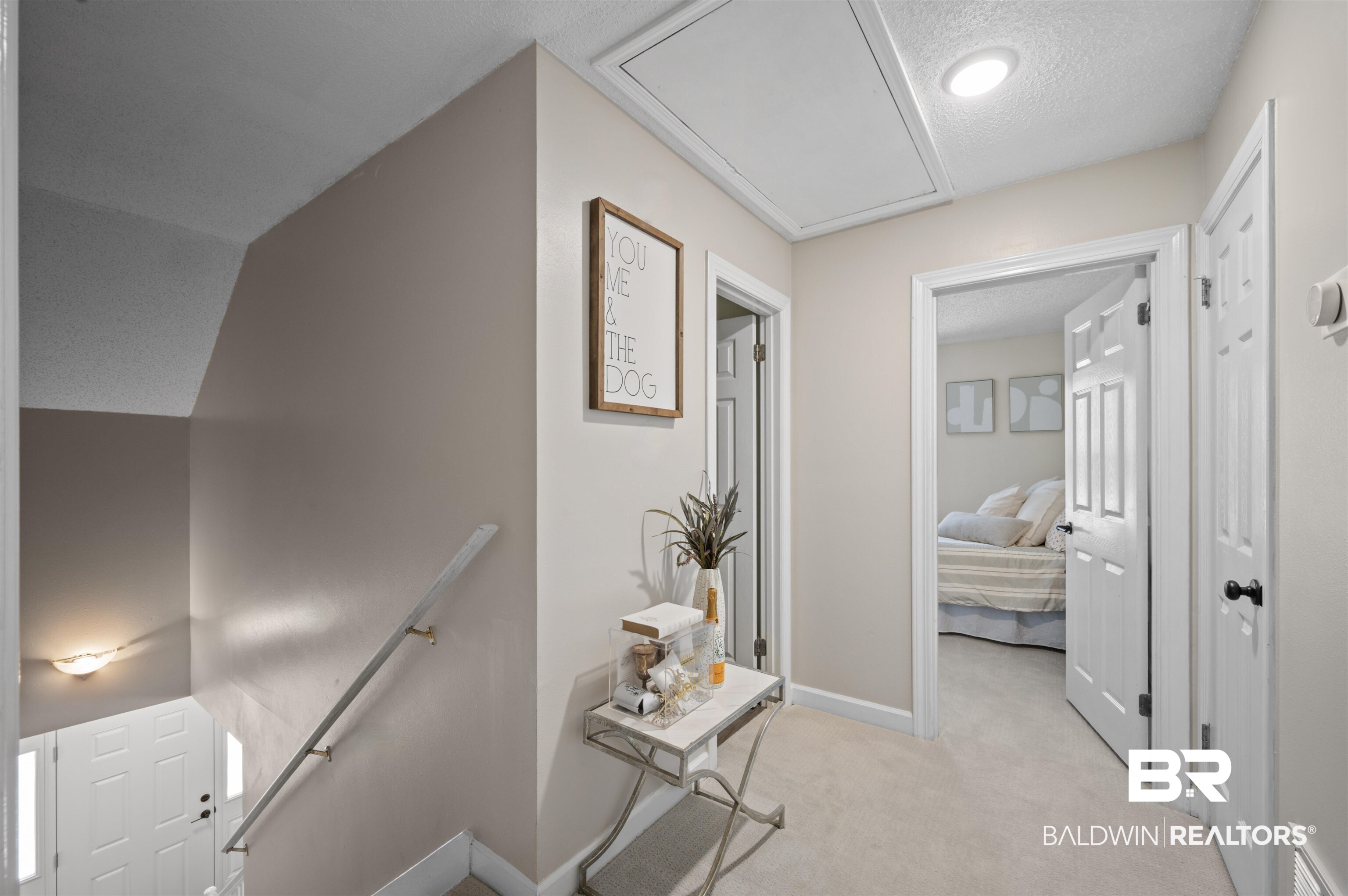 1066 Linlen Avenue Mobile, AL 36609 - Photo 16 of 22 Hall featuring an upstairs landing, visible vents, baseboards, attic access, and light carpet
