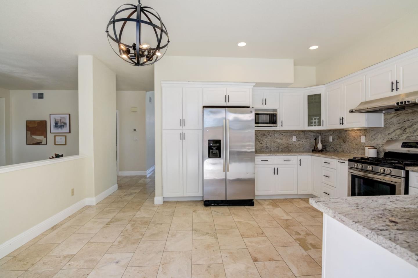 2699 Ramsdell Place San Jose, CA 95148 - Photo 11 of 40 a kitchen with stainless steel appliances granite countertop a refrigerator and a stove top oven