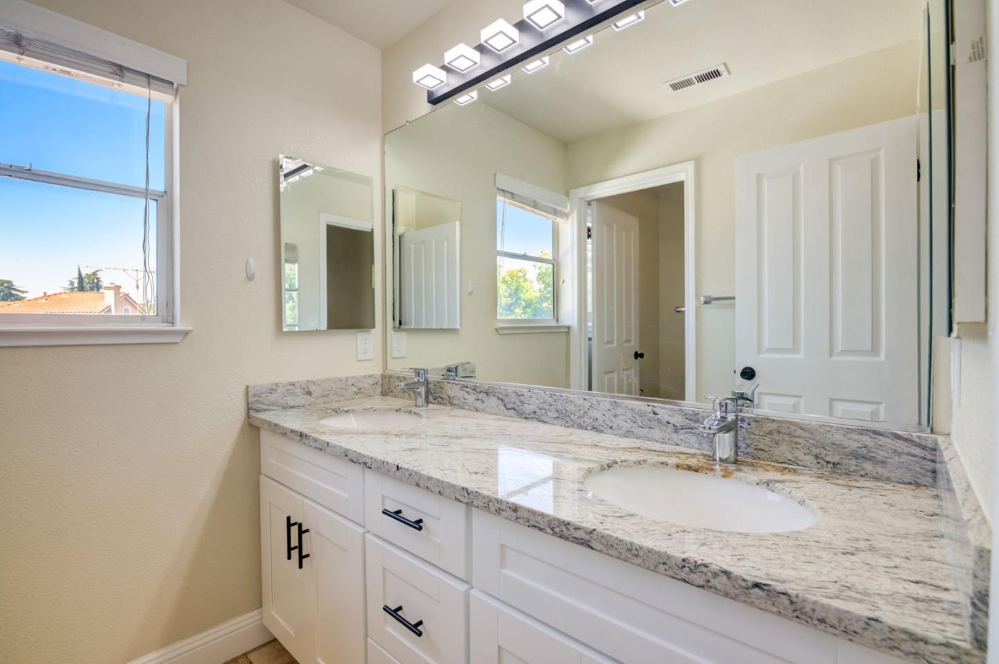2699 Ramsdell Place San Jose, CA 95148 - Photo 25 of 40 a bathroom with a granite countertop sink double and mirror