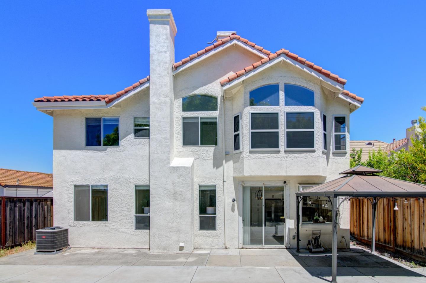 2699 Ramsdell Place San Jose, CA 95148 - Photo 28 of 40 a front view of a house with glass windows and a yard