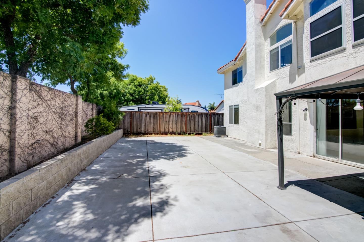 2699 Ramsdell Place San Jose, CA 95148 - Photo 30 of 40 a view of a house with a small yard and wooden fence