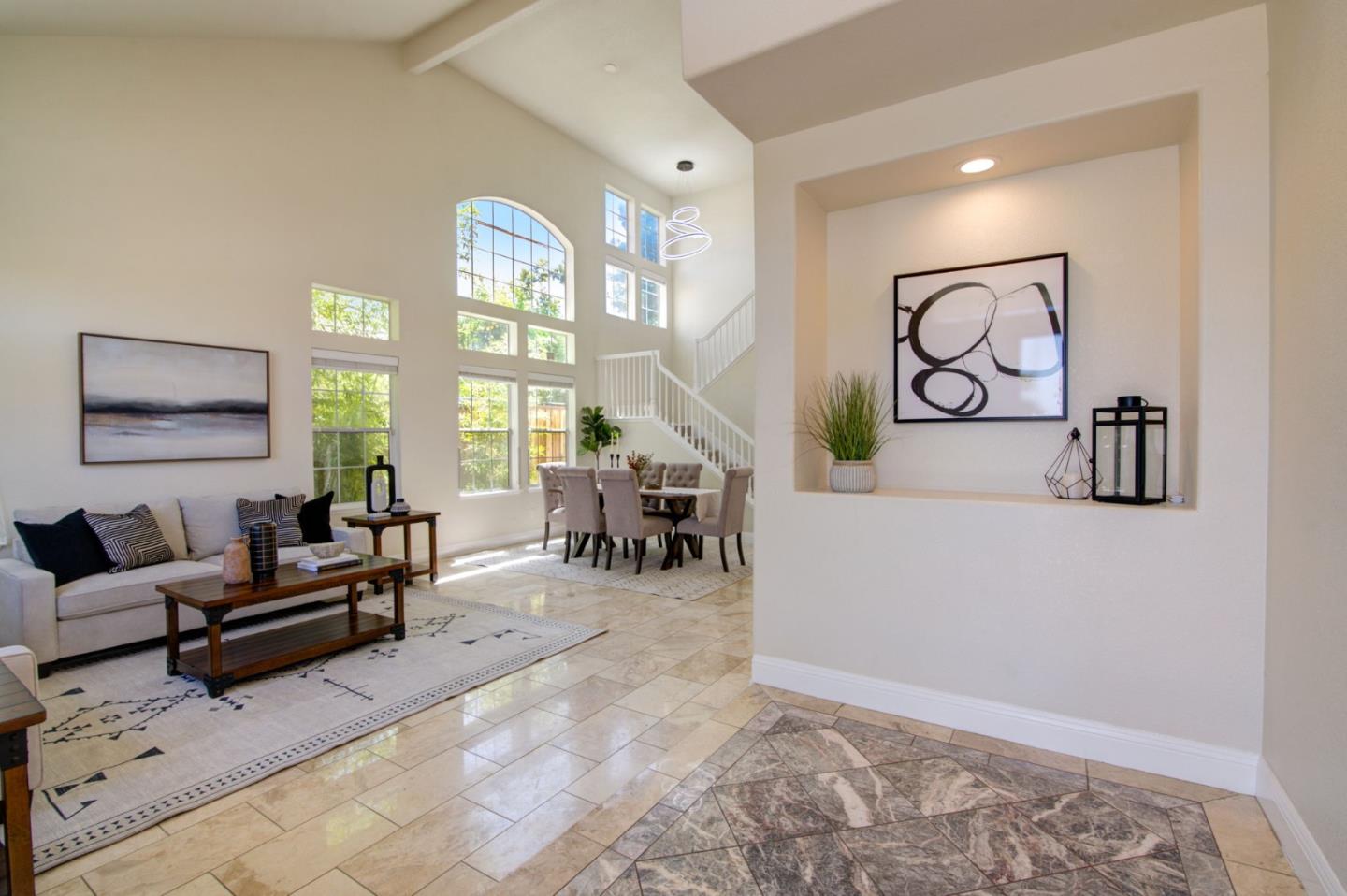 2699 Ramsdell Place San Jose, CA 95148 - Photo 5 of 40 a living room with furniture and a large window
