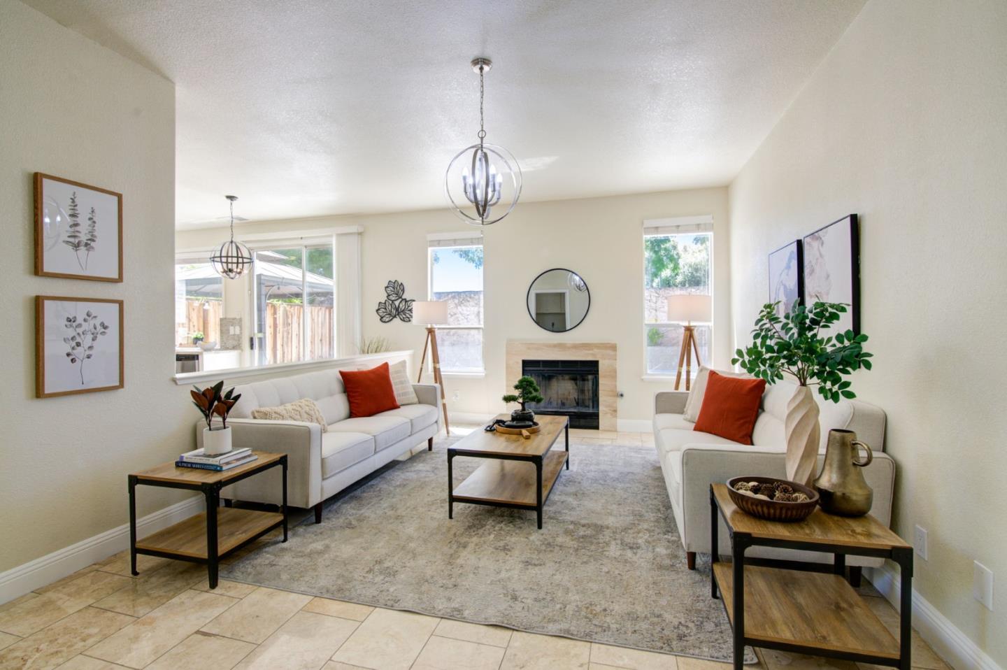 2699 Ramsdell Place San Jose, CA 95148 - Photo 8 of 40 a living room with furniture a clock and a window