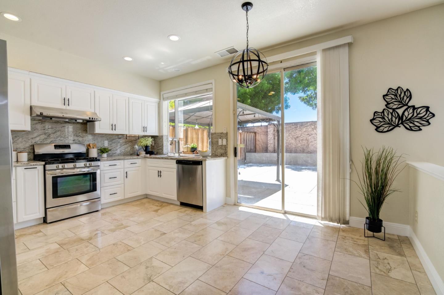 2699 Ramsdell Place San Jose, CA 95148 - Photo 10 of 40 a kitchen with stainless steel appliances granite countertop a stove and a refrigerator