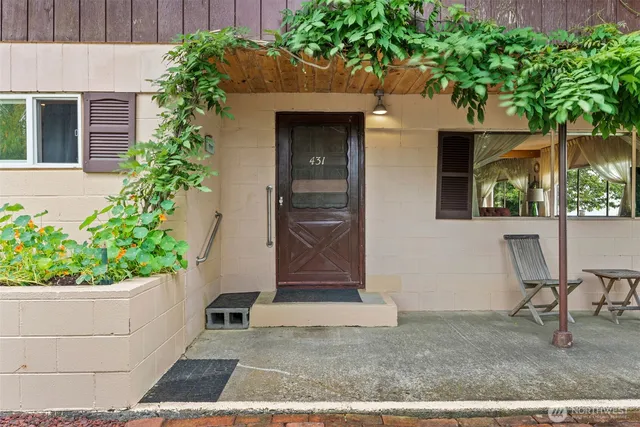 a view of a dining room with furniture a livingroom and chandelier
