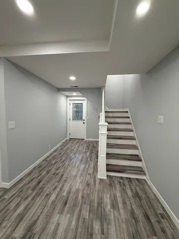 a view of a room with wooden floor and stairs