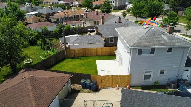 an aerial view of a house with yard